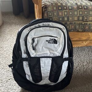 The North Face Black and White Backpack with Multiple Pockets